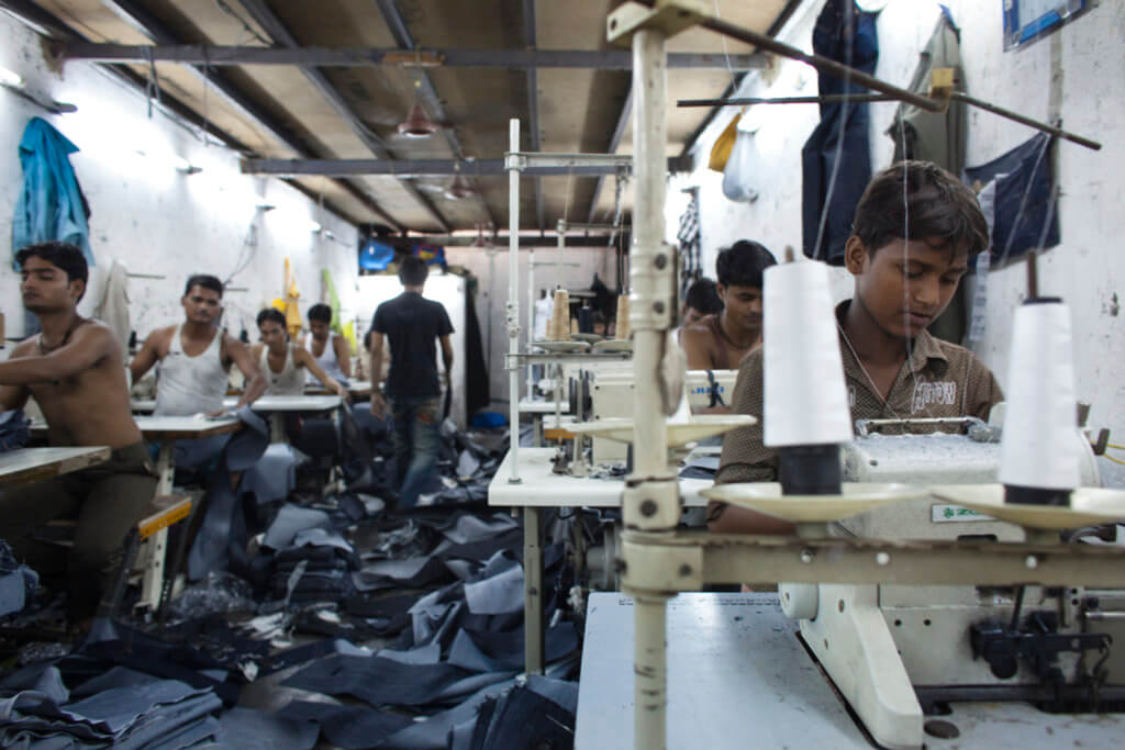 Manufacturing jeans in Dharavi slum, Mumbai, India (Adam Hinton)